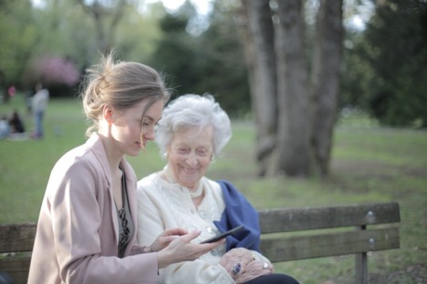 Daughter-explaining-elderly-mother-how-using-smartphone-3791666
